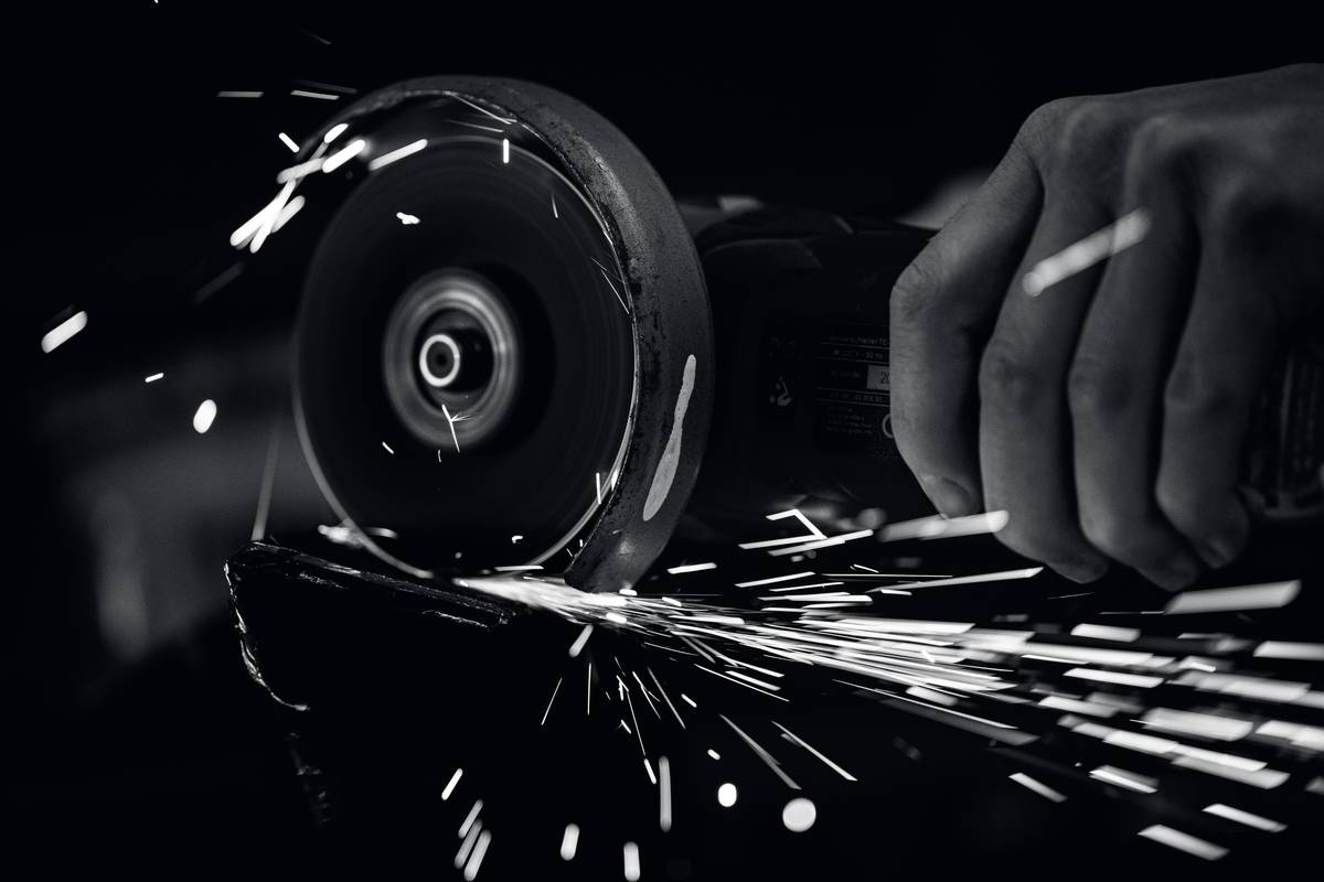 Close-up of a nut grinder in action, grinding a hex nut while clearly showing the depth collar, safety guard, and embedded scale—nut grinder feature how to use